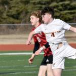 Kenai Central's Zane James and Ketchikan's Conor Pearson battle for the ball Wednesday, April 23, 2025, at Ed Hollier Field at Kenai Central High School in Kenai, Alaska. (Photo by Jeff Helminiak/Peninsula Clarion)