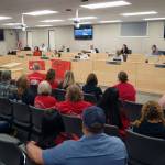 Dozens of supporters of Sterling Elementary School watch as Kenai Peninsula Borough Mayor Peter Micciche speaks during a special meeting of the Kenai Peninsula Borough School District Board of Education in Soldotna, Alaska, on Wednesday, April 23, 2025. (Jake Dye/Peninsula Clarion)
