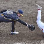 Kenai Centrals Gabe Joanis beats the tag of Homers Henry Wedvik on Friday, April 25, 2025, at the Kenai Little League fields in Kenai, Alaska. (Photo by Jeff Helminiak/Peninsula Clarion)