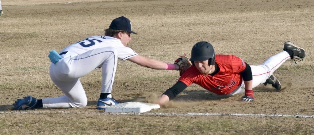Soldotnas Brenden Theel tags out Kenai Centrals Keoni Beddow on Monday, April 28, 2025, at the Soldotna Little League fields in Soldotna, Alaska. (Photo by Jeff Helminiak/Peninsula Clarion)