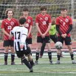 Nikiskis Dylan Hall shoots a direct kick wide against the Kenai Central wall of Everett Poulin, Eli Pancoast, Bridger Begich and Bobby Hayes, and Kenai goalie Ezra Jusmable, on Tuesday, April 29, 2025, at Ed Hollier Field at Kenai Central High School in Kenai, Alaska. (Photo by Jeff Helminiak/Peninsula Clarion)