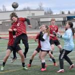 Kenai Centrals Diego Huerta heads the ball in front of Nikiski defender Jayden Anderson and goalie Emily Brannen on Tuesday, April 29, 2025, at Ed Hollier Field at Kenai Central High School in Kenai, Alaska. (Photo by Jeff Helminiak/Peninsula Clarion)