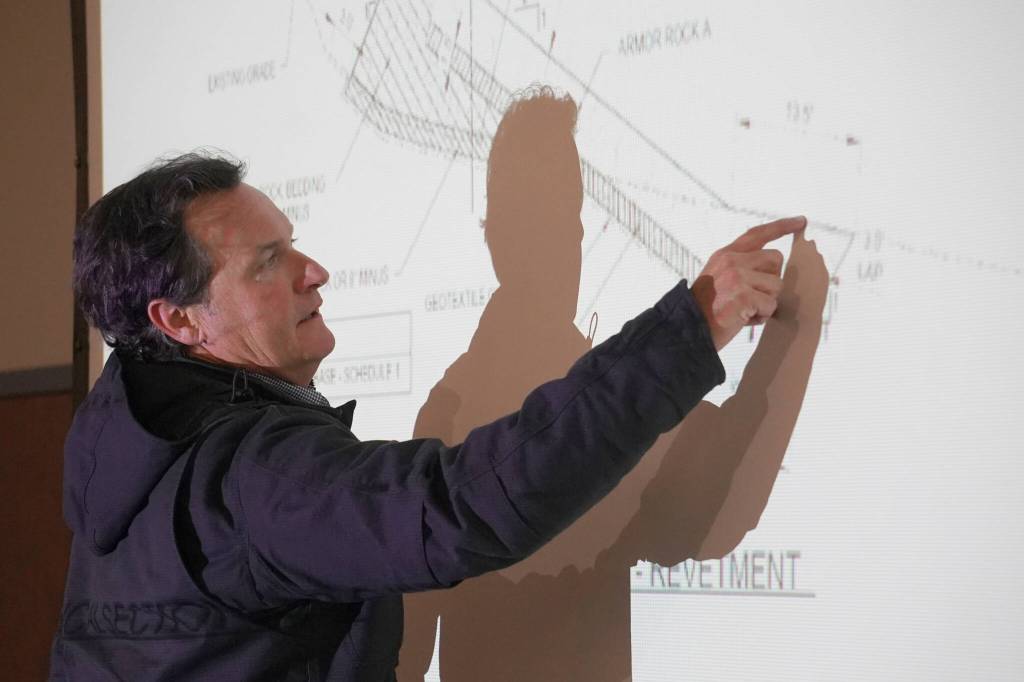 Project Manager Jerrod Stafford, of Western Marine Construction, points to a map of the Kenai River Bluff Stabilization Project while giving an update on the project in Kenai, Alaska, on Wednesday, April 30, 2025. (Jake Dye/Peninsula Clarion)