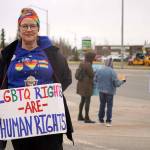 Michele Vasquez stands as part of a May Day protest alongside the Sterling Highway in Soldotna, Alaska, on Thursday, May 1, 2025. (Jake Dye/Peninsula Clarion)