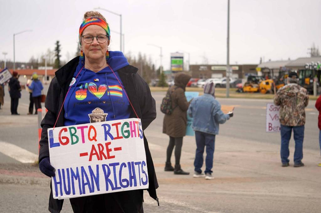Michele Vasquez stands as part of a May Day protest alongside the Sterling Highway in Soldotna, Alaska, on Thursday, May 1, 2025. (Jake Dye/Peninsula Clarion)