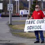 Brian Krauklis, a Sterling Elementary School teacher, protests the possible closure of Sterling Elementary School along the Sterling Highway in Soldotna, Alaska, on Saturday, May 3, 2025. (Jake Dye/Peninsula Clarion)