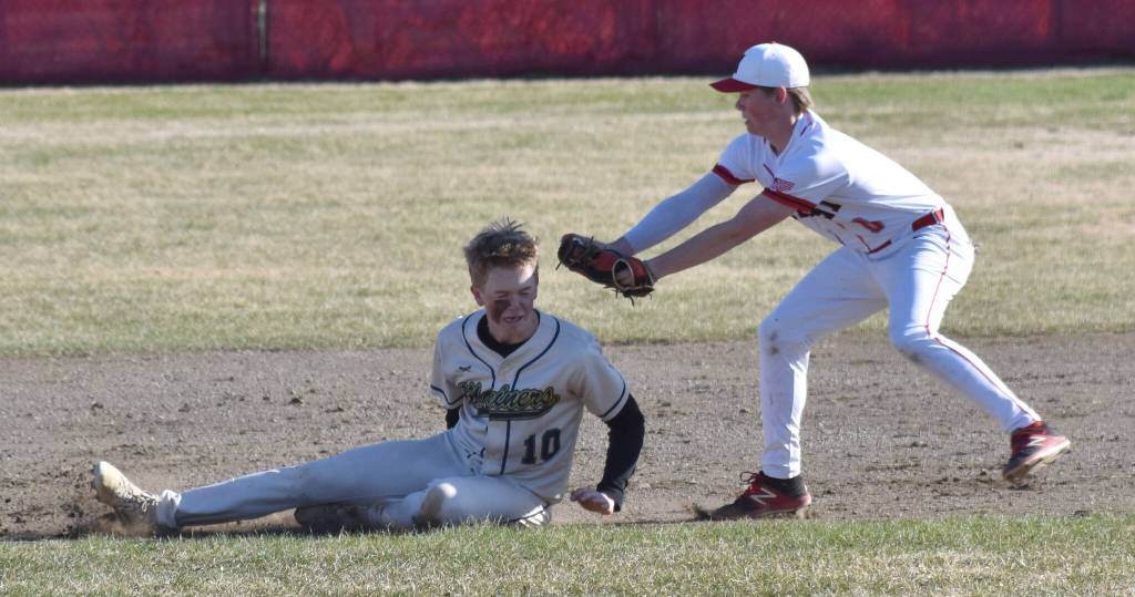 Kenai Centrals Everett Chamberlain tags out Homers Henry Wedvik in a rundown Friday, May 9, 2025, at the Kenai Little League fields in Kenai, Alaska. (Photo by Jeff Helminiak/Peninsula Clarion)