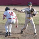 Homer second baseman Austin Briscoe turns a double play in front of Kenai Centrals Avery Martin on Friday, May 9, 2025, at the Kenai Little League fields in Kenai, Alaska. (Photo by Jeff Helminiak/Peninsula Clarion)