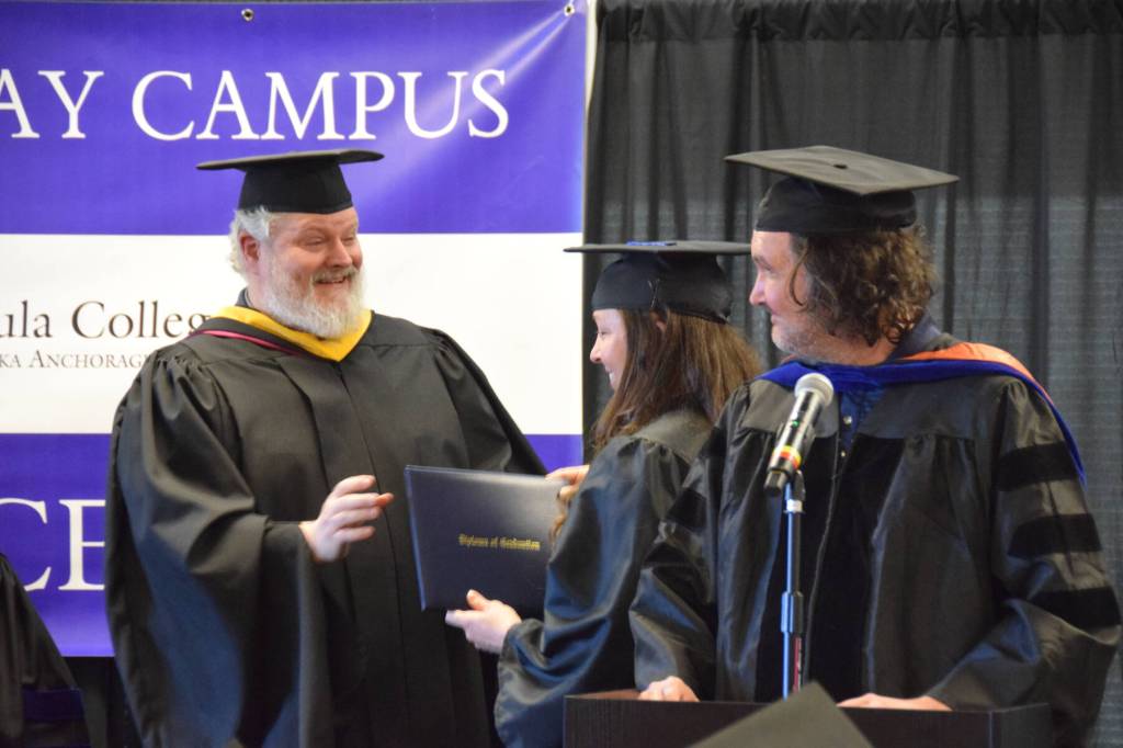 Dr. Jeff Johnson (right), Professor of Mathematics, and campus director Brian Partridge (left) present Emily Sloth (center) with her medical assisting certificate at the 55th annual commencement ceremony on Wednesday, May 7, 2025, at Kachemak Bay Campus in Homer, Alaska. (Delcenia Cosman/Homer News)