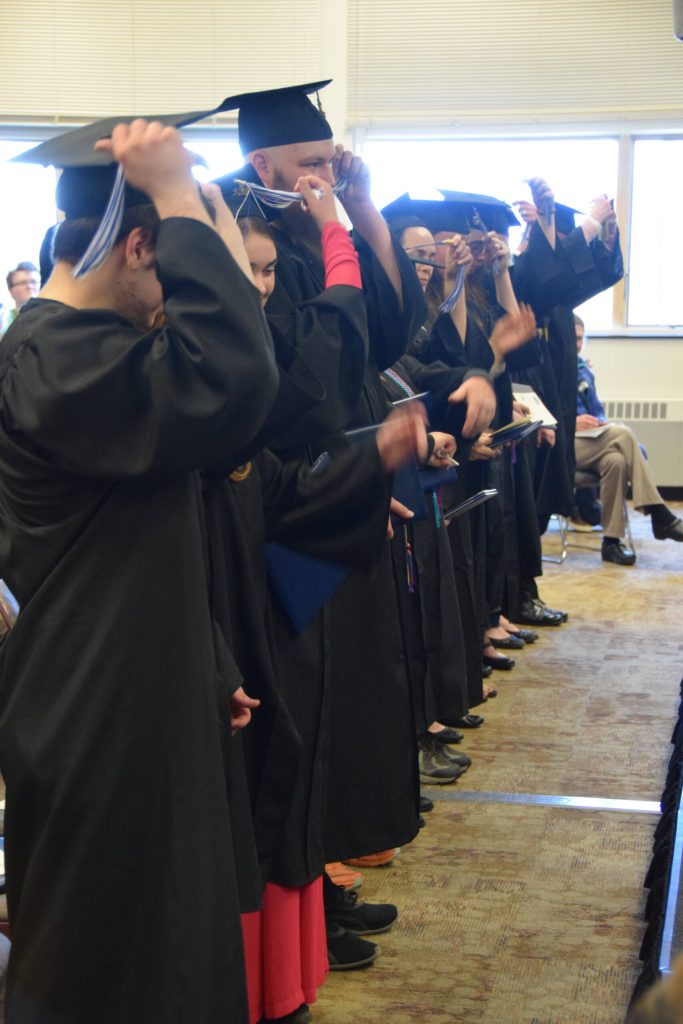 The graduating class of 2025 switch their tassels upon the conferral of degrees at the 55th annual commencement ceremony on Wednesday, May 7, 2025, at Kachemak Bay Campus in Homer, Alaska. (Delcenia Cosman/Homer News)