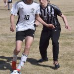 Kenai Centrals Lucas Swanson shields the ball from Nikiskis Shane Hall on Friday, May 16, 2025, at Nikiski Middle-High School in Nikiski, Alaska. (Photo by Jeff Helminiak/Peninsula Clarion)
