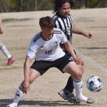Kenai Centrals Sawyer Vann shields the ball from Nikiskis Frank Nasibog on Friday, May 16, 2025, at Nikiski Middle-High School in Nikiski, Alaska. (Photo by Jeff Helminiak/Peninsula Clarion)