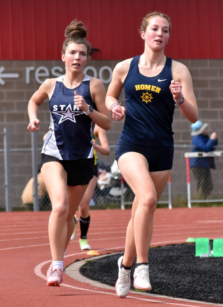 Homers Claira Booz leads Soldotnas Annie Burns in the 1,600-meter run Saturday, May 17, 2025, at the Kenai Peninsula Borough meet at Ed Hollier Field at Kenai Central High School in Kenai, Alaska. (Photo by Jeff Helminiak/Peninsula Clarion)