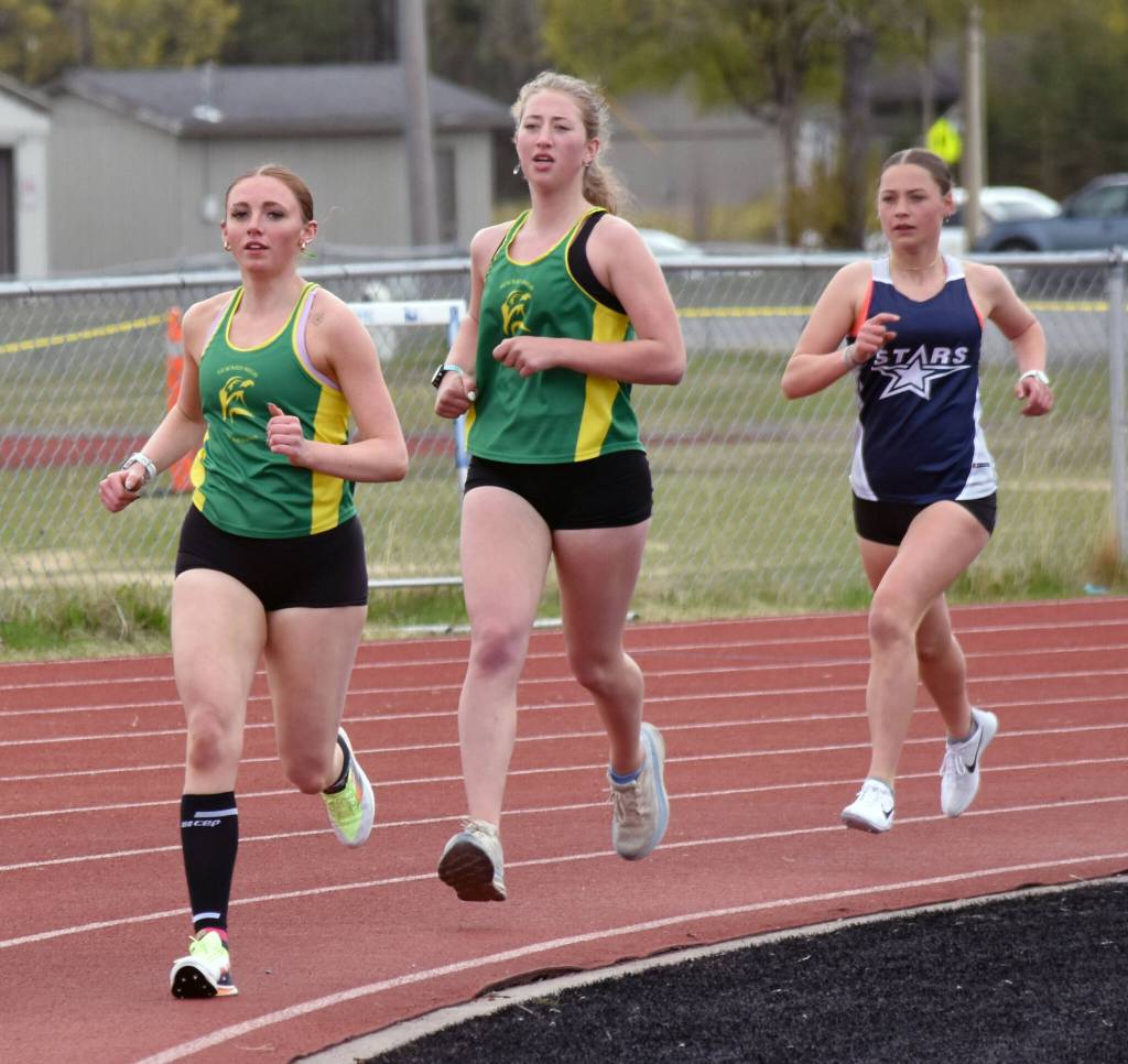 Sewards Indigo Leslie leads Sewards Katie Van Buskirk and Soldotnas Katie Cox on the way to winning the 3,200-meter run Saturday, May 17, 2025, at the Kenai Peninsula Borough meet at Ed Hollier Field at Kenai Central High School in Kenai, Alaska. (Photo by Jeff Helminiak/Peninsula Clarion)