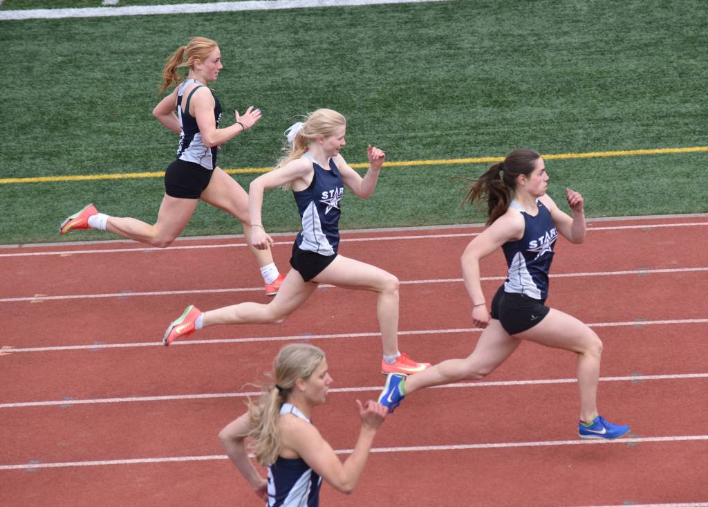 From top, Lucy Uhlir, Sophia Jedlicki, Shiloh Zichko and Sarah Brown compete in the 200-meter dash Saturday, May 17, 2025, at the Kenai Peninsula Borough meet at Ed Hollier Field at Kenai Central High School in Kenai, Alaska. (Photo by Jeff Helminiak/Peninsula Clarion)