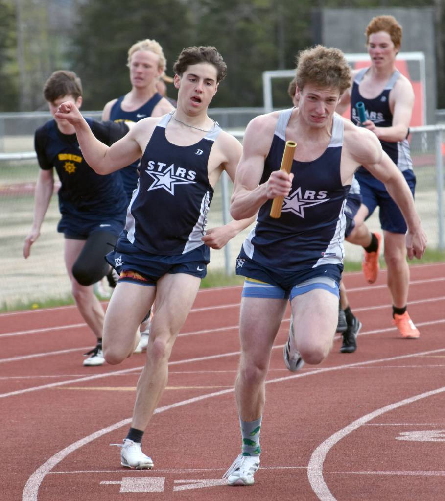 Soldotnas Tyce Escott hands to James Innes in the 400-meter relay Saturday, May 17, 2025, at the Kenai Peninsula Borough meet at Ed Hollier Field at Kenai Central High School in Kenai, Alaska. (Photo by Jeff Helminiak/Peninsula Clarion)