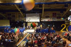 Seniors throw their graduation caps in jubilant celebration while attendees fling beach balls in the air from the bleachers during the 2025 Homer High School graduation ceremony on Wednesday, May 21, 2025, in the Alice Witte Gymnasium. (Chloe Pleznac/Homer News)