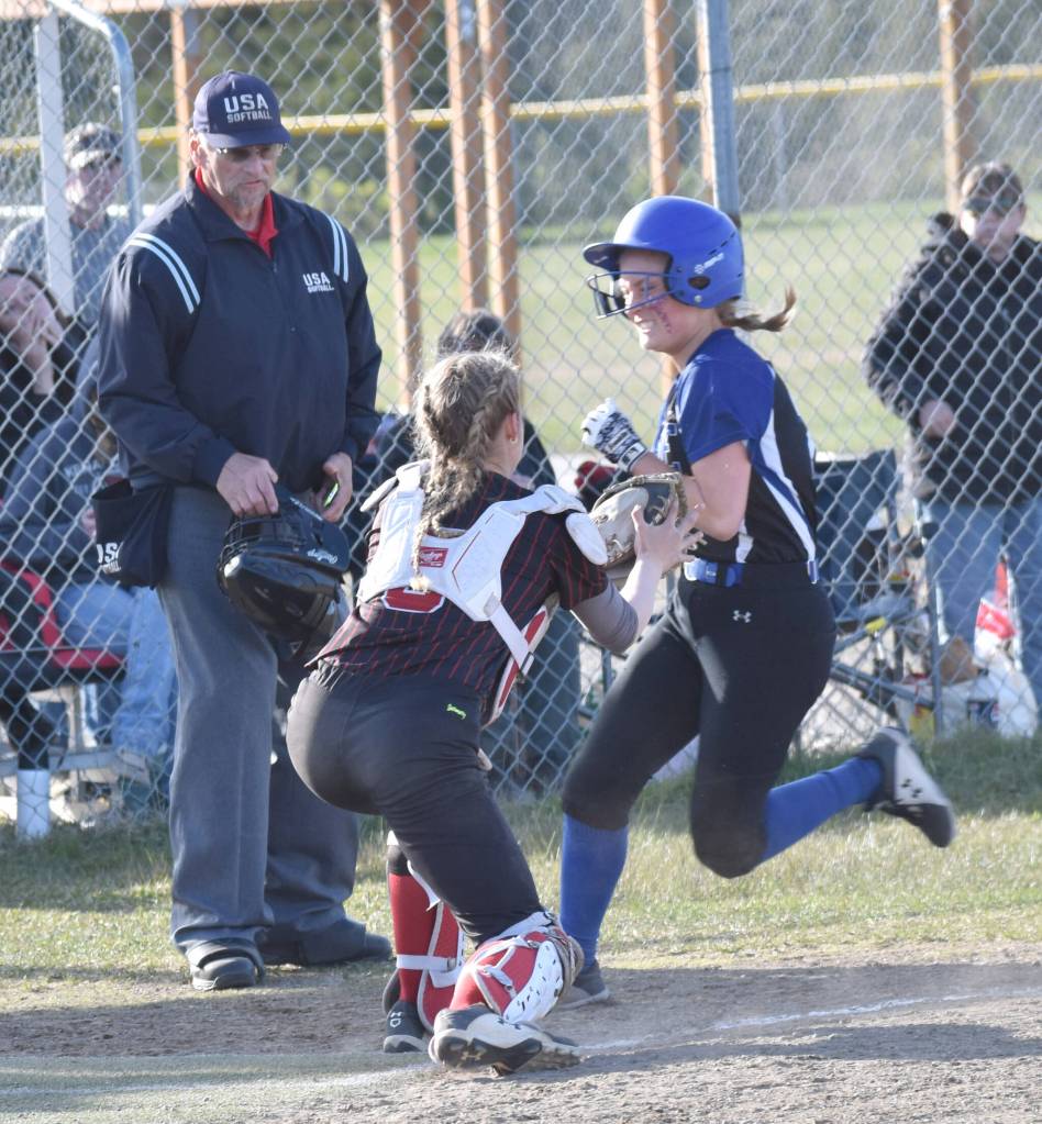 Palmers Jane Meals is tagged out by Kenai Central catcher Avia Miller during the first game of a doubleheader Friday, May 23, 2025, at Steve Shearer Memorial Ball Park in Kenai, Alaska. (Photo by Jeff Helminiak/Peninsula Clarion)