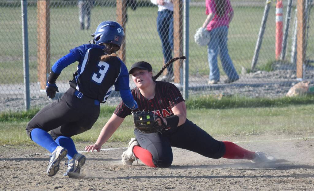 Palmers Lizzy McQuillin gets into third base safely in front of Kenai Centrals Kailey Stynsberg on Friday, May 23, 2025, at Steve Shearer Memorial Ball Park in Kenai, Alaska. (Photo by Jeff Helminiak/Peninsula Clarion)