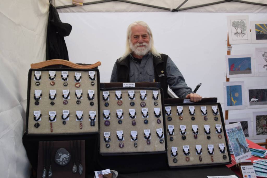 Scott Miller poses with his collection of handmade jewelry on Saturday, May 24 at the Homer Farmers Market. (Chloe Pleznac/Homer News)