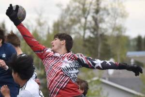 Soldotna defender Daniel Heath and goalie Luke Hillyer sky through the air to keep the ball out of the net Thursday, May 22, 2025, at Justin Maile Field at Soldotna High School in Soldotna, Alaska. (Photo by Jeff Helminiak/Peninsula Clarion)