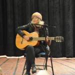 Sunrise Kilcher Sjoeberg performs a song during the 2025 Mary Epperson Day celebration on May 30 at Pier One Theatre on the Spit. (Chloe Pleznac/Homer News)
