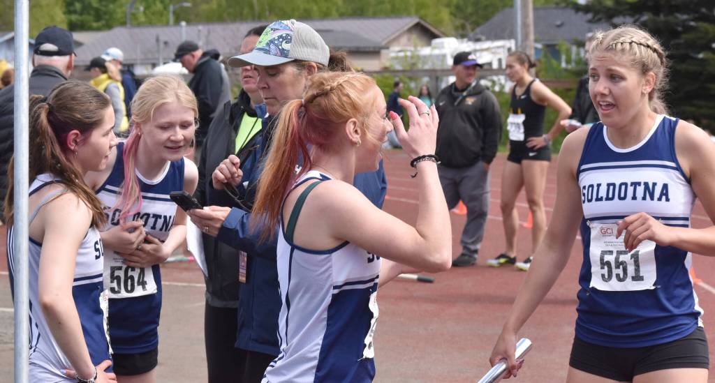 Soldotnas Shiloh Zichko, Sophia Jedlicki, Lucy Uhlir and Sarah Brown celebrate a state title and school record in the 800-meter relay with assistant coach Krista Arthur on Saturday, May 31, 2025, at the Division I state track meet at Dimond High School in Anchorage, Alaska. (Photo by Jeff Helminiak/Peninsula Clarion)