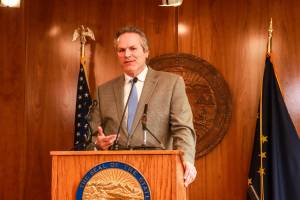Gov. Mike Dunleavy speaks to reporters at the Alaska State Capitol on Thursday, April 17, 2025. (Jasz Garrett / Juneau Empire file photo)