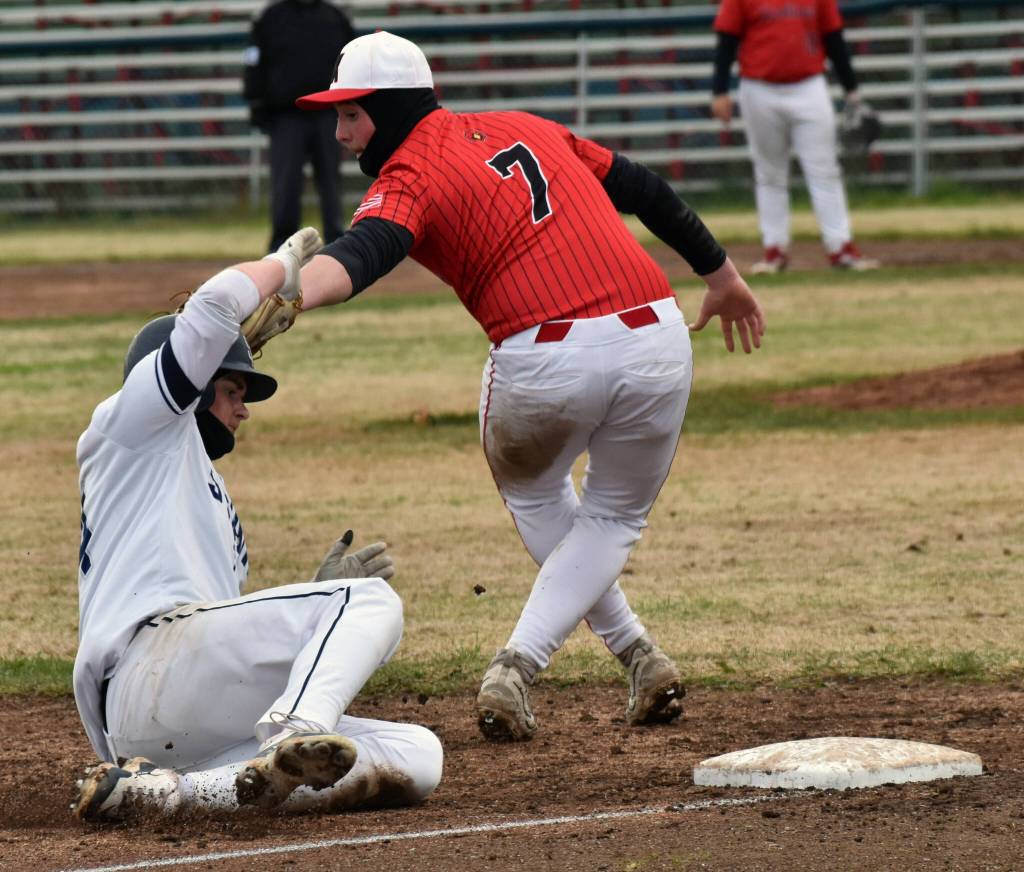Soldotnas Wyatt Gagnon slides safely into third behind Gabe Joanis at the Division II state baseball tournament at Coral Seymour Memorial Park in Kenai, Alaska, on Saturday, June 7, 2025. (Photo by Jeff Helminiak/Peninsula Clarion)