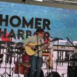 Local musician Silas Luke Jones performs blindfolded during his performance at the inaugural HomerFest on the Homer Spit on Saturday. (Chloe Pleznac/Homer News)