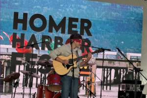 Local musician Silas Luke Jones performs blindfolded during his performance at the inaugeral HomerFest on the Homer Spit in Homer, Alaska on Saturday, June 7, 2025. (Chloe Pleznac/Homer News)