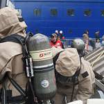 National Guard members put on hazmat suits before entering the simulation area on Monday, June 9, 2025. (Natalie Buttner / Juneau Empire)