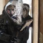 National Guard members in hazmat suits use an iPad to take reconnaissance photos of a mock chemical weapons lab simulation site on Monday, June 9, 2025. (Natalie Buttner / Juneau Empire)