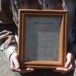 Larry Bernbeck holds a birth certificate he made for Tugster when beginning the build back in 2023 on Thursday, June 5, 2025 in Homer, Alaska. (Chloe Pleznac/Homer News). (Chloe Pleznac/Homer News)