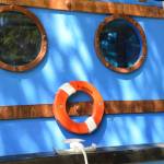 Little port windows, tinted blue on Thursday, June 5, 2025 in Homer, Alaska. (Chloe Pleznac/Homer News)