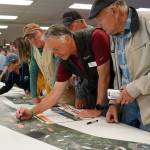Leads for the Sterling Safety Corridor Improvements Project field questions and showcase their preferred design during an open house meeting at the Soldotna Regional Sports Complex in Soldotna, Alaska, on Tuesday, June 10, 2025. (Jake Dye/Peninsula Clarion)