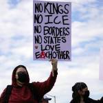 People carrying flags and signs line the Sterling Highway for a No Kings protest in Soldotna, Alaska, on Saturday, June 14, 2025. (Jake Dye/Peninsula Clarion)