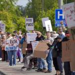 People carrying flags and signs line the Sterling Highway for a No Kings protest in Soldotna, Alaska, on Saturday, June 14, 2025. (Jake Dye/Peninsula Clarion)