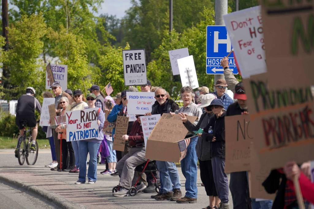 People carrying flags and signs line the Sterling Highway for a No Kings protest in Soldotna, Alaska, on Saturday, June 14, 2025. (Jake Dye/Peninsula Clarion)