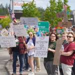 People carrying flags and signs line the Sterling Highway for a No Kings protest in Soldotna, Alaska, on Saturday, June 14, 2025. (Jake Dye/Peninsula Clarion)
