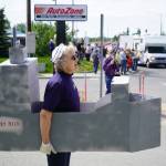 A woman dressed as the USNS Harvey Milk stands along the Sterling Highway for a No Kings protest in Soldotna, Alaska, on Saturday, June 14, 2025. (Jake Dye/Peninsula Clarion)
