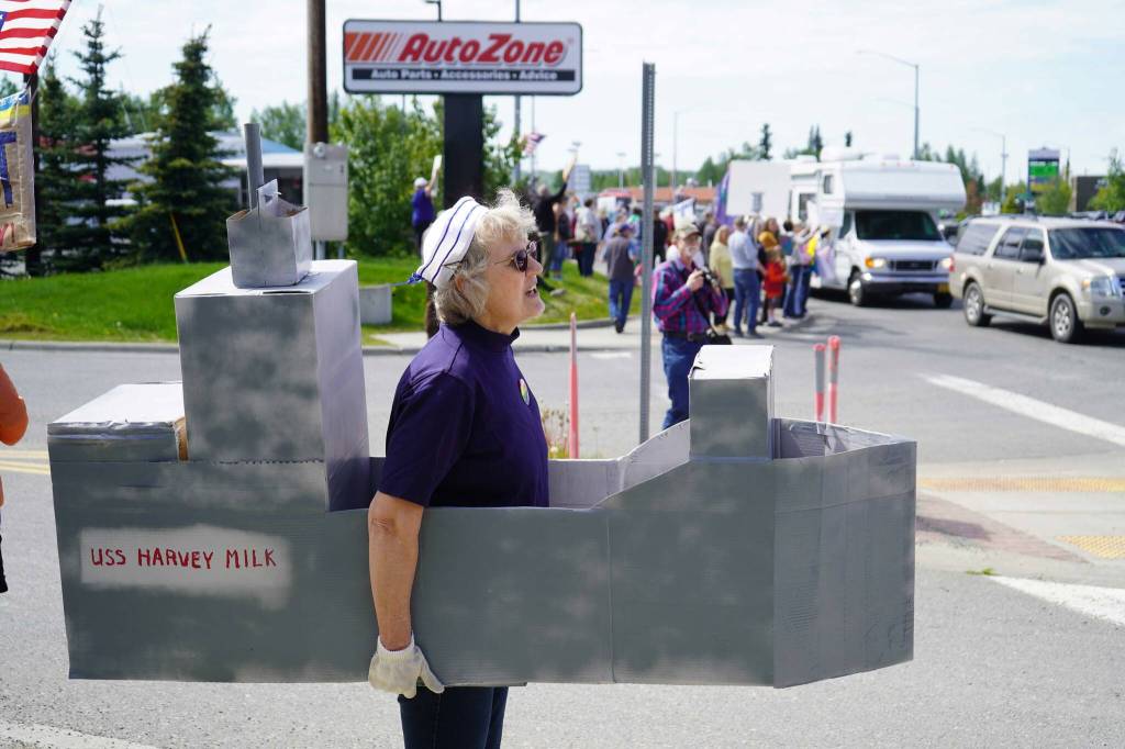 A woman dressed as the USNS Harvey Milk stands along the Sterling Highway for a No Kings protest in Soldotna, Alaska, on Saturday, June 14, 2025. (Jake Dye/Peninsula Clarion)