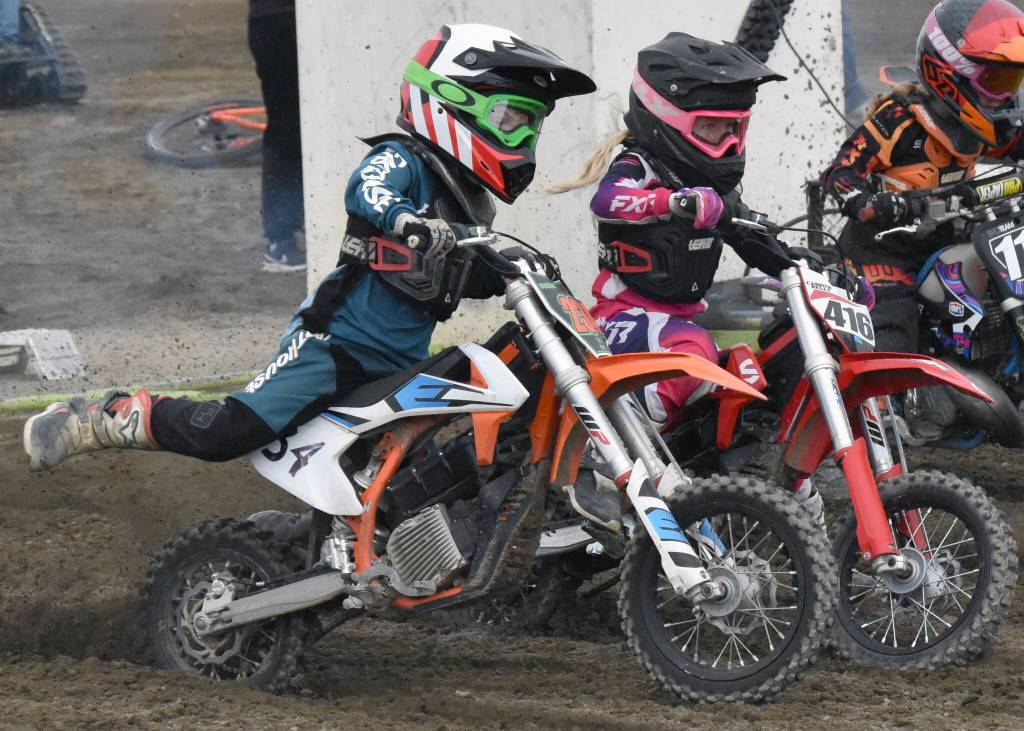 Davis Loyer of Palmer and Camryn Kelly of Soldotna race 50 intermediate at the Alaska State Motocross Series Race 4 on Sunday, June 15, 2025, at Twin City Raceway in Kenai, Alaska. (Photo by Jeff Helminiak/Peninsula Clarion)