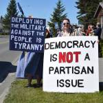 Demonstrators stand with signs during the No Kings protest in Homer, Alaska, on Saturday, June 14, 2025. (Chloe Pleznac/Homer News)