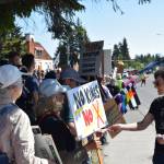 Susannah Webster hands out informational cards to demonstrators on Saturday, June 14, 2025, at the No Kings demonstration in Homer, Alaska. (Chloe Pleznac/Homer News)