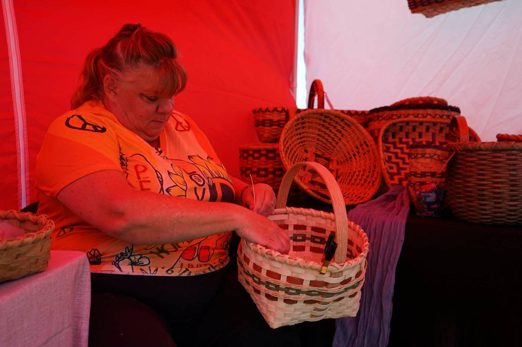 Carolyn Jennings, of Weavin and Things, crafts baskets during Saturday Market at the Goods in Soldotna, Alaska, on Saturday, June 14, 2025. (Jake Dye/Peninsula Clarion)