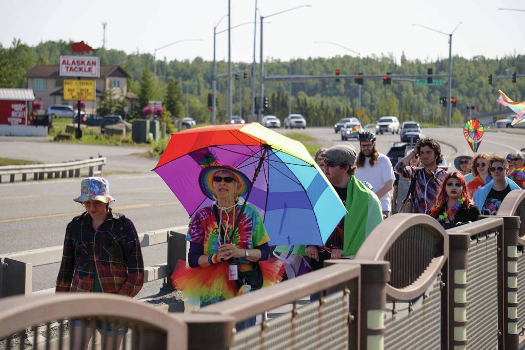 A pride march moves along the Sterling Highway through Soldotna, Alaska, on Saturday, June 14, 2025. (Jake Dye/Peninsula Clarion)