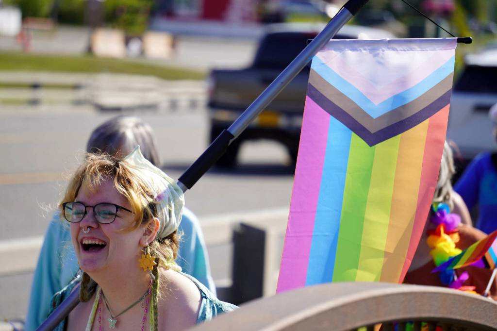 A Pride march moves along the Sterling Highway through Soldotna, Alaska, on Saturday, June 24, 2025. (Jake Dye/Peninsula Clarion)
