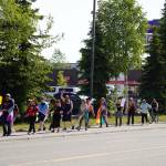 A Pride march moves along the Sterling Highway through Soldotna, Alaska, on Saturday, June 24, 2025. (Jake Dye/Peninsula Clarion)