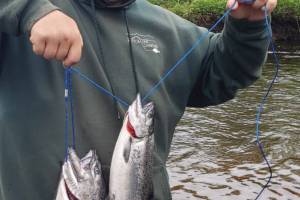 Hunter Kirby holds up the hatchery king salmon he bagged during the one-day youth fishery on the Ninilchik River on Wednesday, June 7, 2023 in Ninilchik, Alaska. Photo by Mike Booz